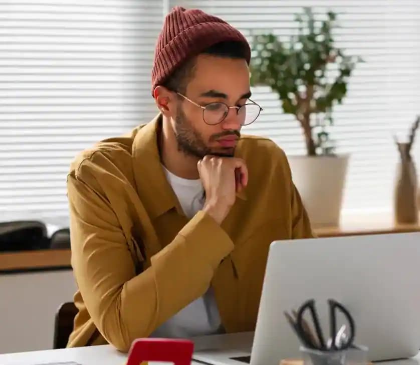 Main image of two people working in front of a laptop